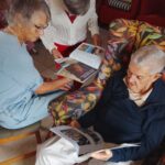 Alastair, marion & Joan looking at photos & magazines Alastair, marion & Joan looking at photos & magazines
